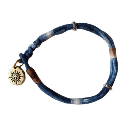 Vegetable indigo-dyed cotton bracelet with brass pendant